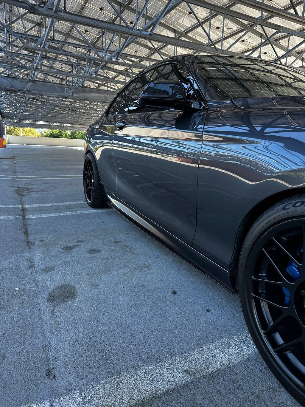 Kies Motorsports — close-up of the carbon fiber weave and edge finish on F22/F23 performance side skirt extension, showing quality detail