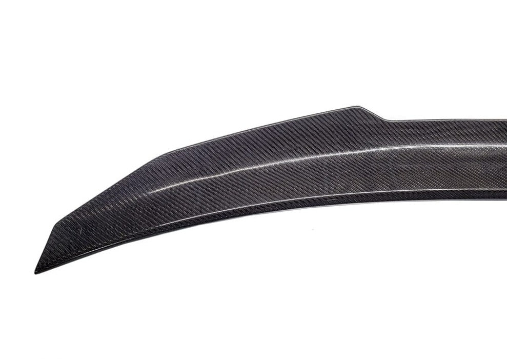 Kies Motorsports — rear three-quarter angle of BMW G22 with PSM aggressive carbon spoiler, showing how the high kick extends upward from the decklid