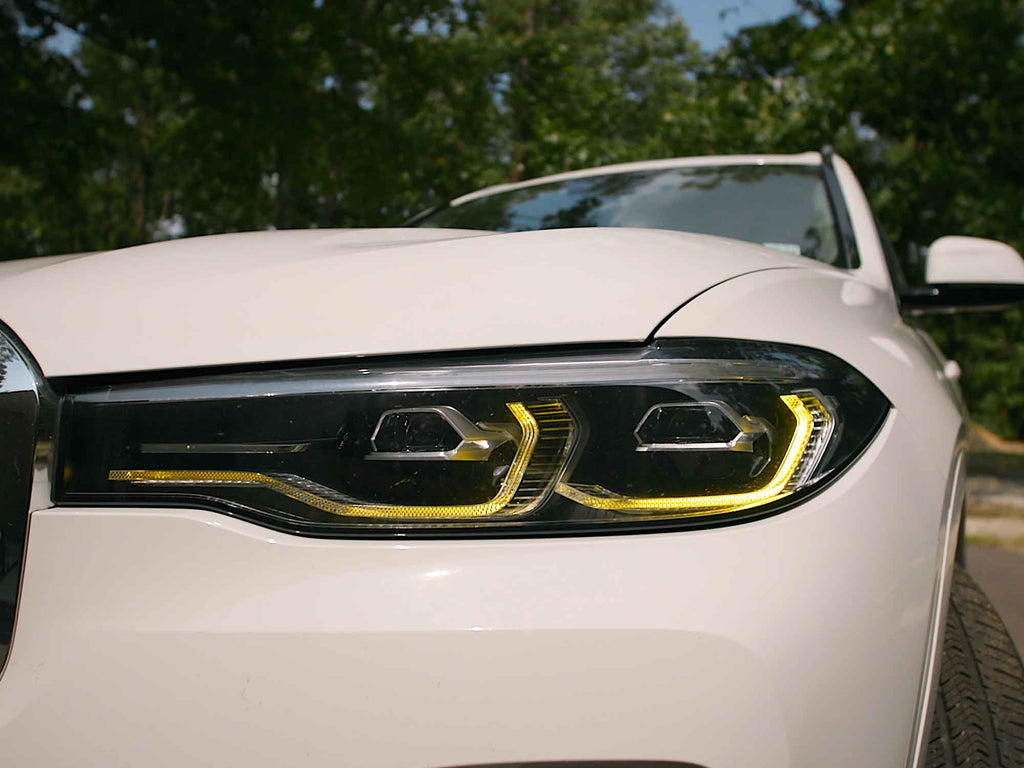 Kies Motorsports — Kies yellow DRL harness connected to BMW X7 headlight module showing plug-and-play fit