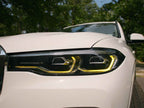 Kies Motorsports — Kies yellow DRL harness connected to BMW X7 headlight module showing plug-and-play fit