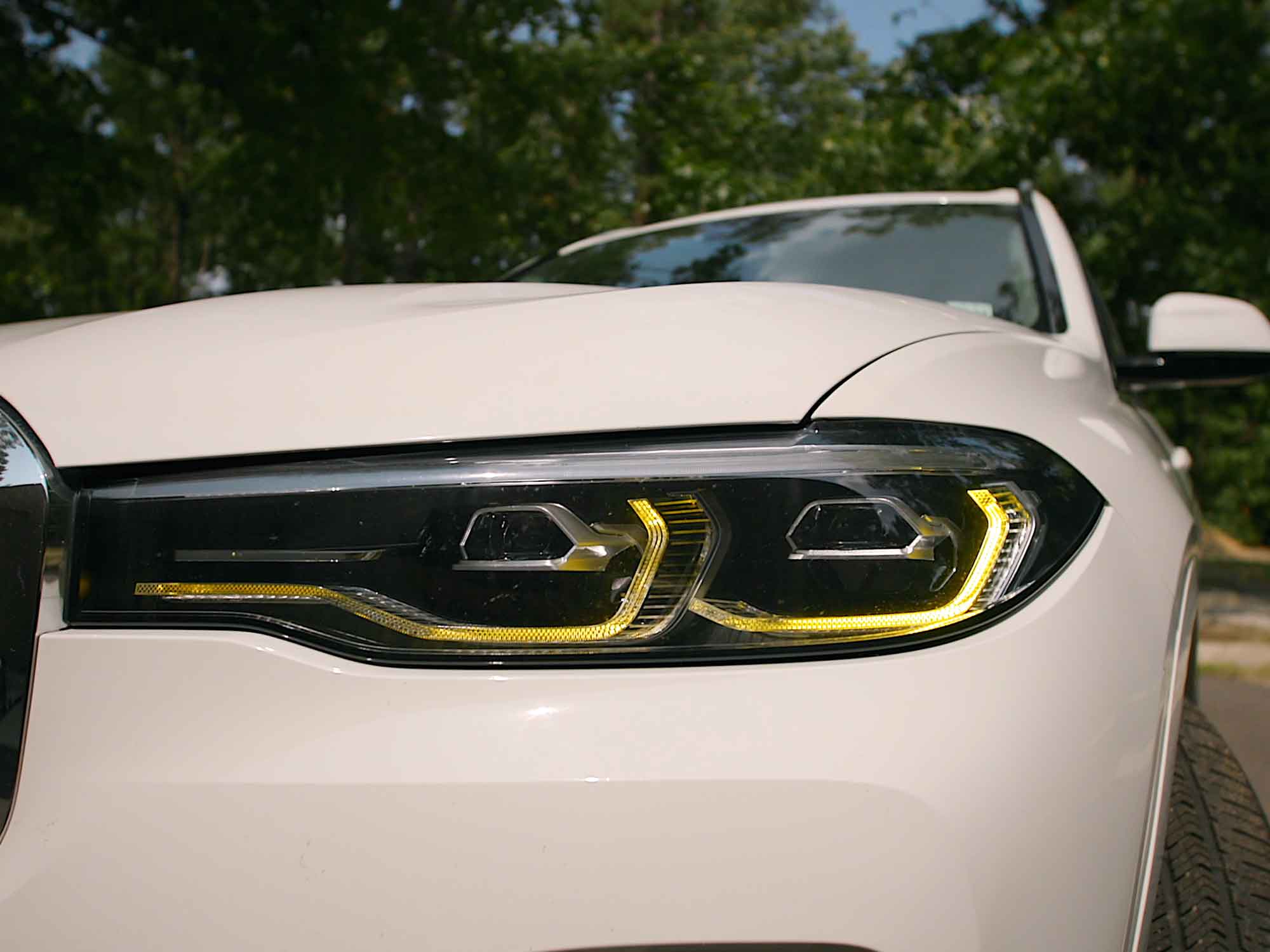 Kies Motorsports — Kies yellow DRL harness connected to BMW X7 headlight module showing plug-and-play fit