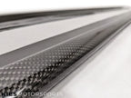 Kies Motorsports — pair of Kies Carbon 3D style side skirt extensions for F32/F33 laid out before installation, carbon fiber gloss finish