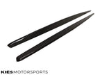 Kies Motorsports — pair of carbon fiber side skirt extensions for F22/F23 laid flat, showing gloss finish and carbon weave pattern