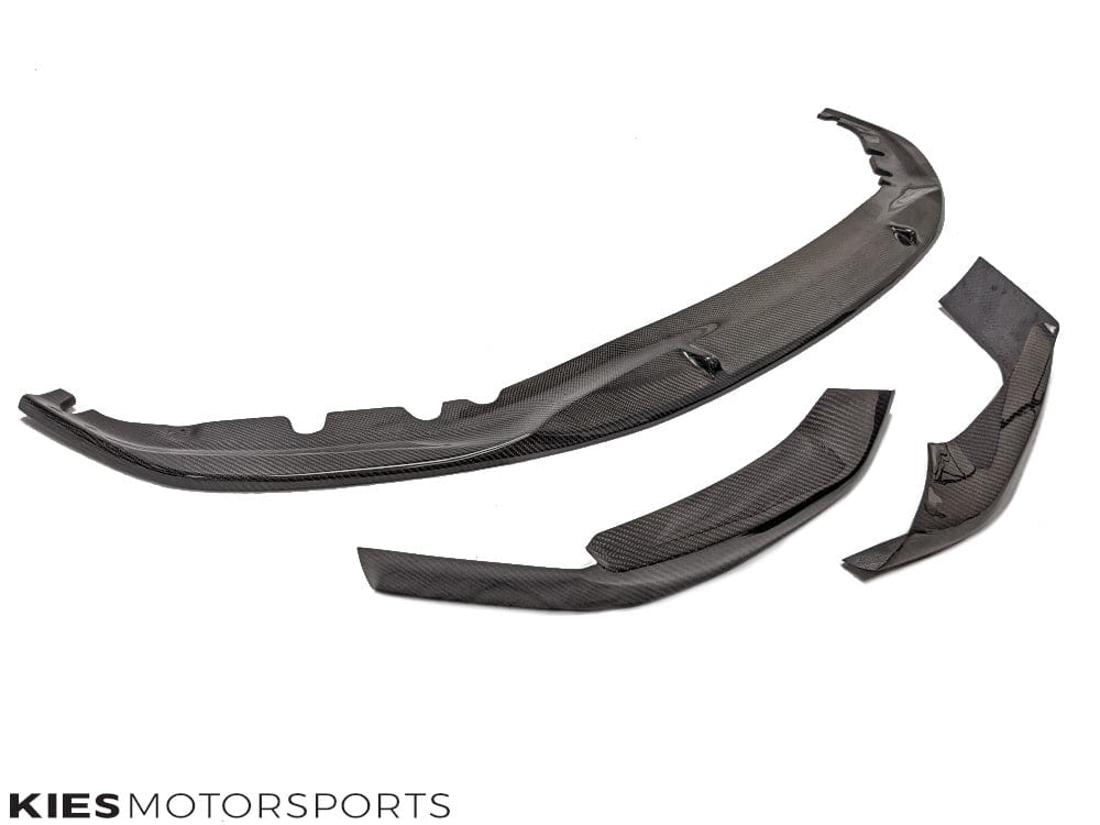 Kies Motorsports — three-piece performance carbon fiber front lip kit for BMW G30 laid out, showing all sections and carbon weave pattern