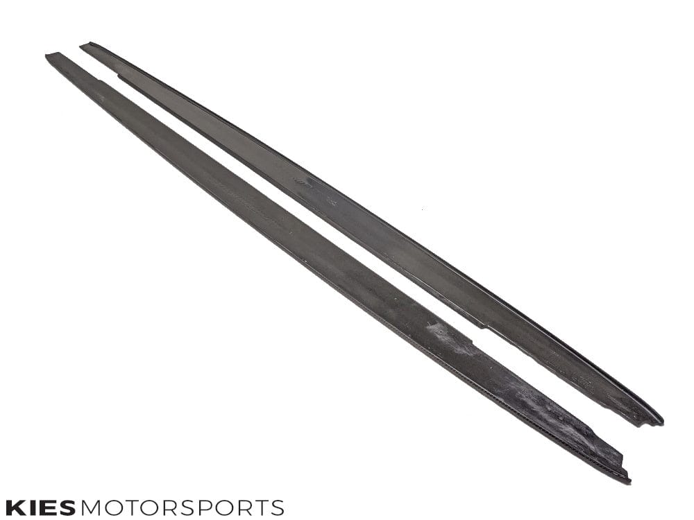 Kies Motorsports — pair of carbon fiber side skirt extensions for BMW G30 5 Series displayed, showing gloss carbon finish and side profile shape
